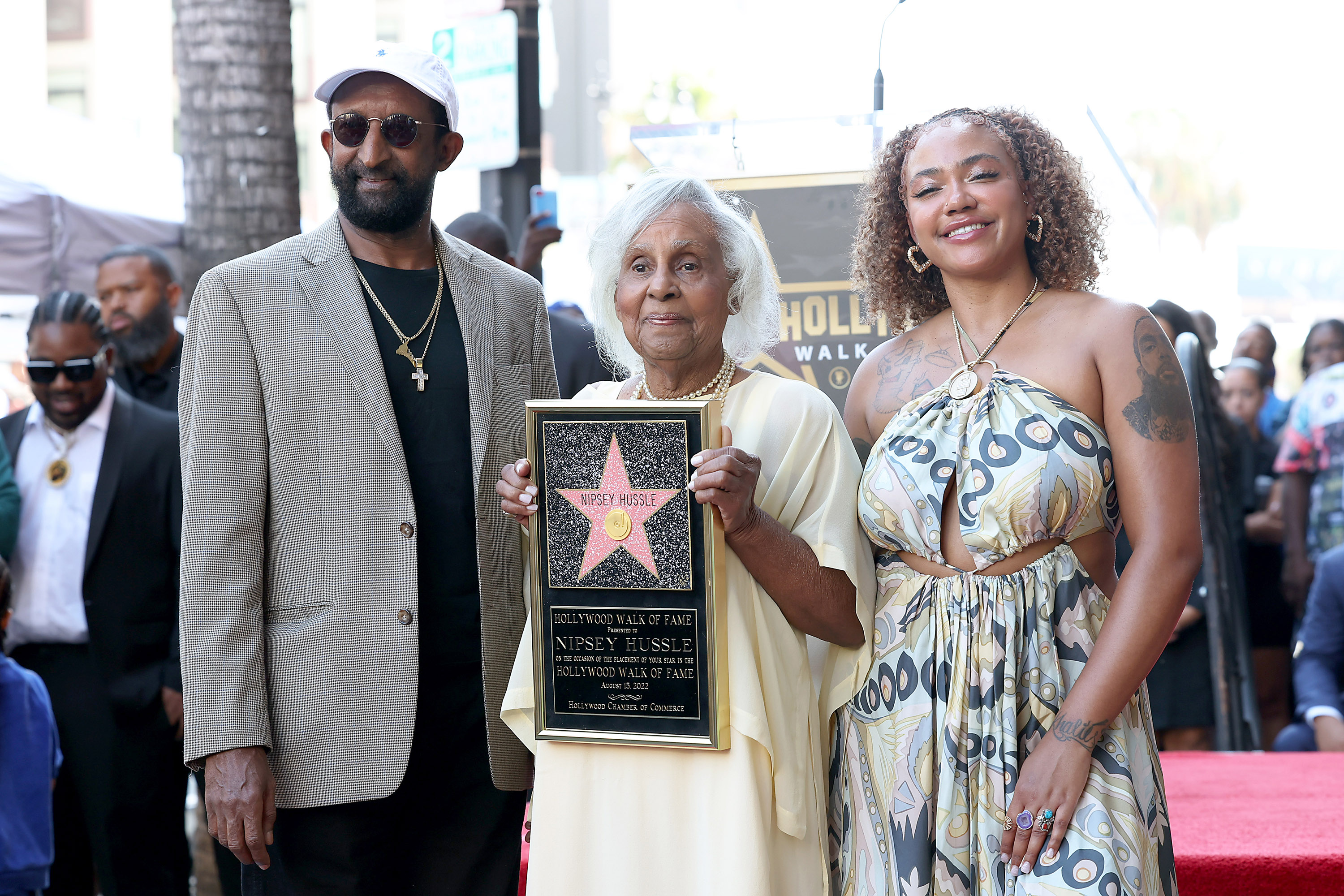 (L-R) Dawit Asghedom, Margaret Boutte, and Samantha Smith are seen as Nipsey Hussle is posthumously honored with a star on The Hollywood Walk of Fame on Aug. 15, 2022, in Los Angeles, Calif.