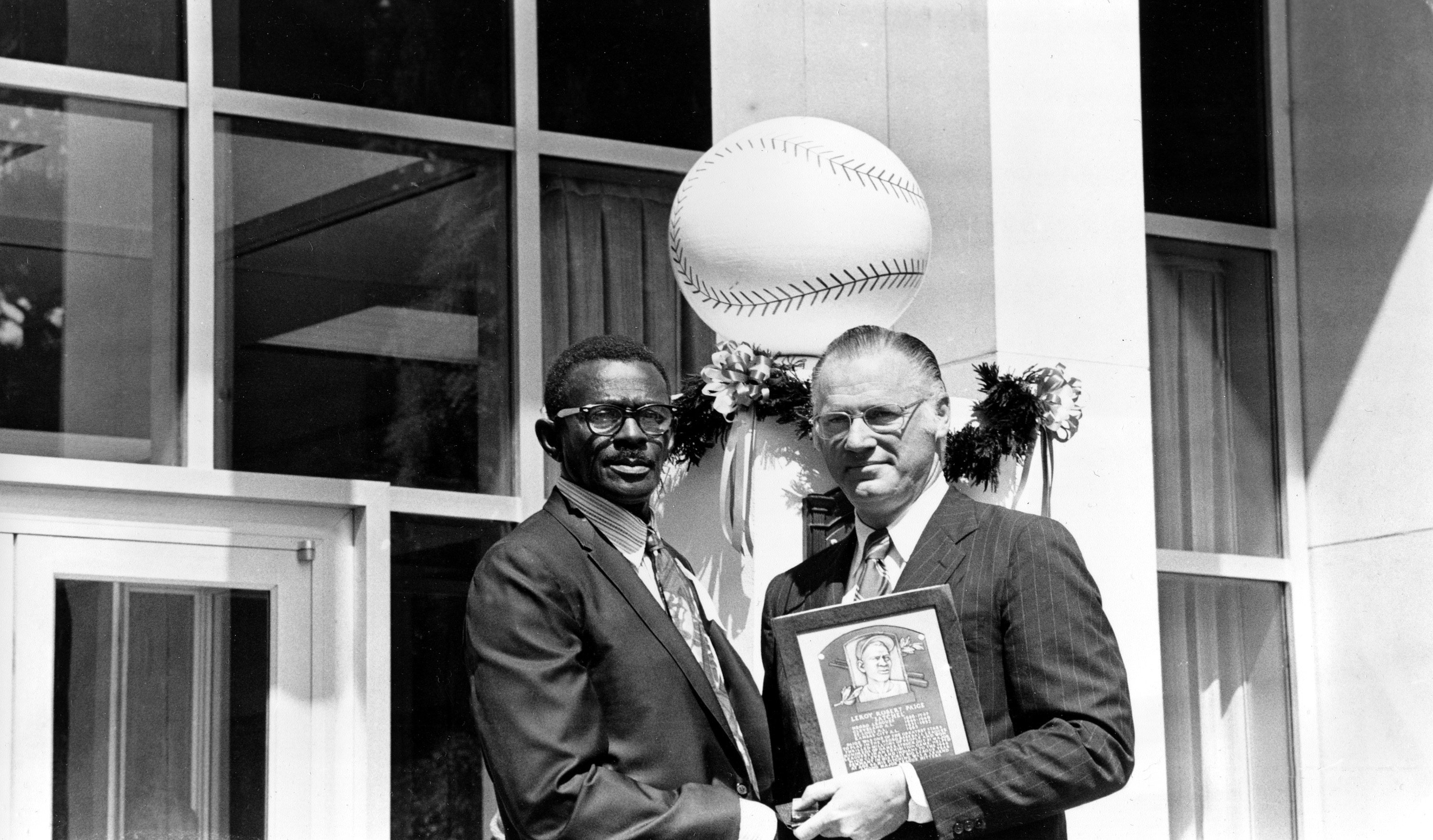 Satchel Paige, left, receives a plaque designating him as Member of the Baseball Hall of Fame from Baseball Commissioner Bowie Kuhn at the Hall of Fame Building in Cooperstown, NY on Aug. 9, 1971.