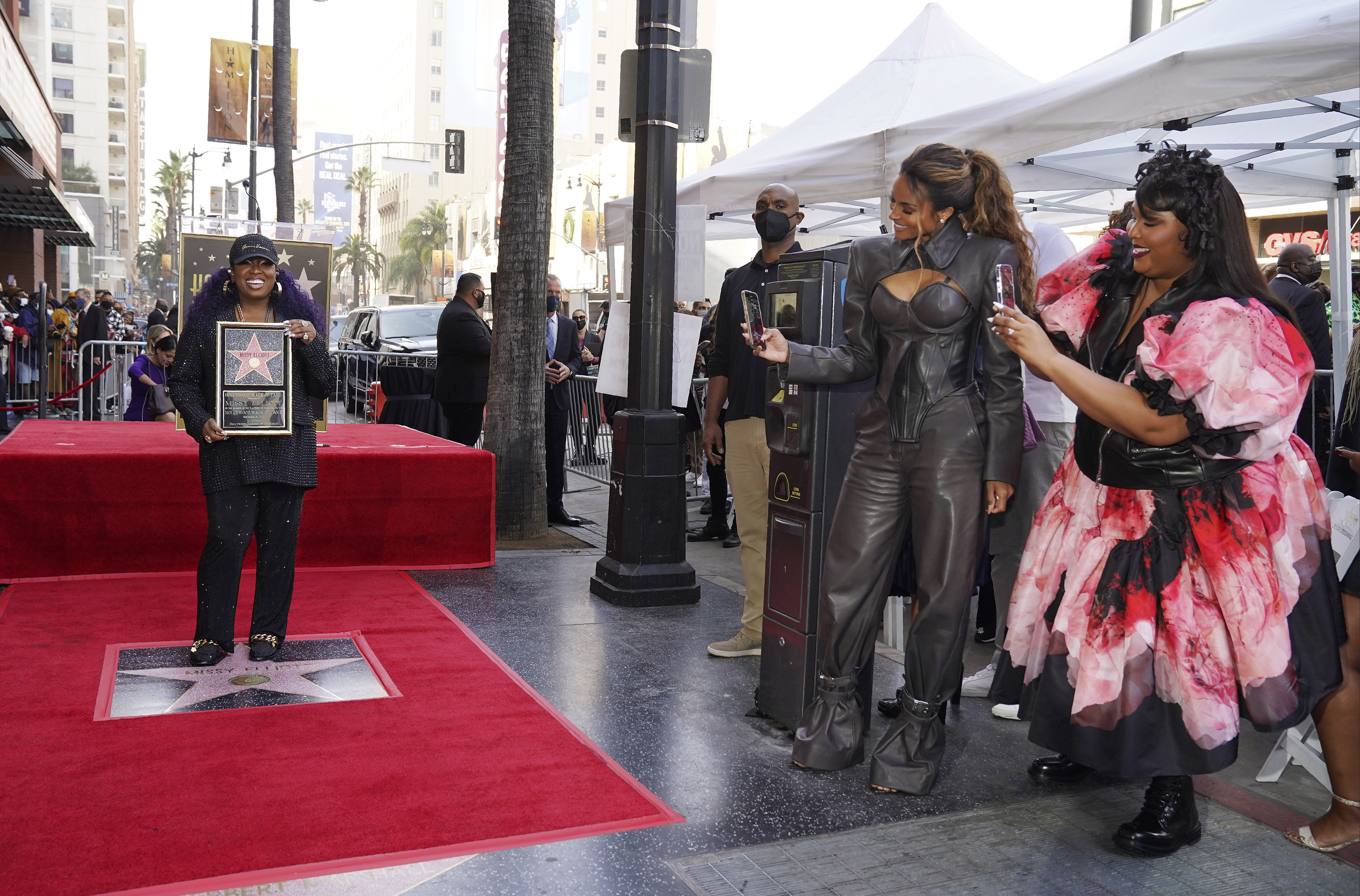 Singers Lizzo, far right, and Ciara, second from right, take pictures of hip hop artist Missy Elliott during a ceremony to award her a star on the Hollywood Walk of Fame, Monday, Nov. 8, 2021, in Los Angeles.