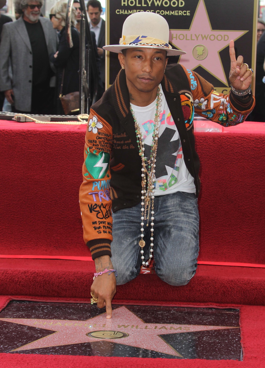 Musician, fashion designer and record producer Pharrell Williams kneels down besides his well-deserved star on the Hollywood Walk of Fame on Dec. 4, 2014. Aside from being successful in the music industry, Williams also went on to produce his two design labels called Billionaire Boys Club and Ice Cream as well as his own record label i am OTHER.