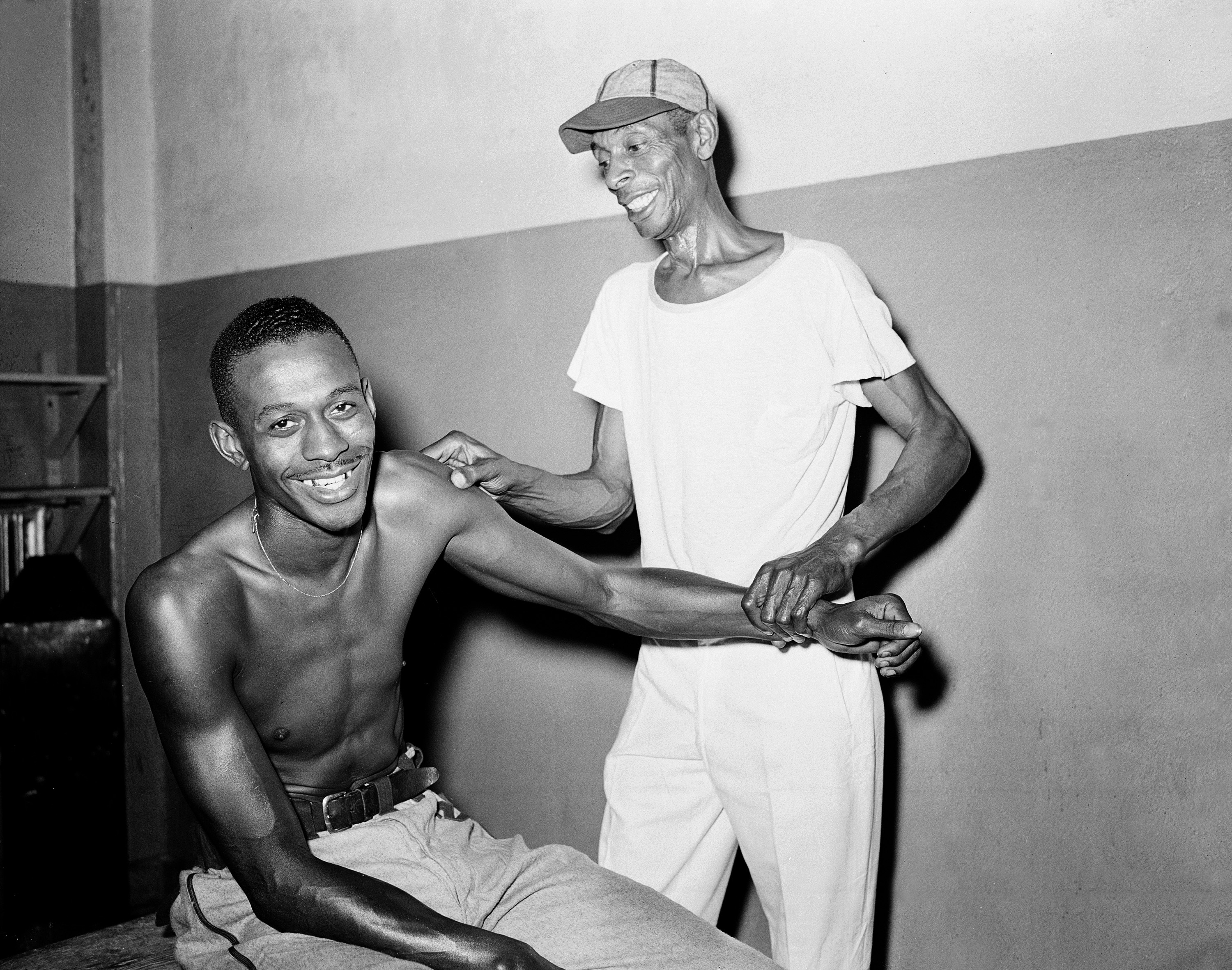 Satchel Paige, right-handed pitcher for the Kansas City Monarchs of the Negro American League (NAL), has his pitching arm massaged by team trainer Frank J. Floyd in New York on Aug. 2, 1942.
