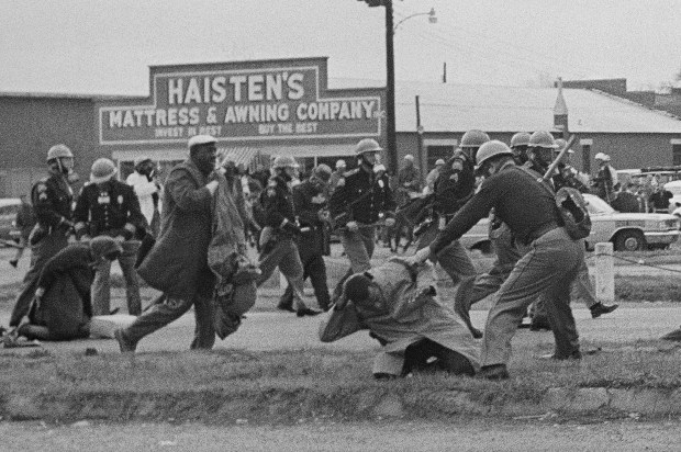 State troopers swing billy clubs to break up a civil rights voting march in Selma, Ala., March 7, 1965. (AP)