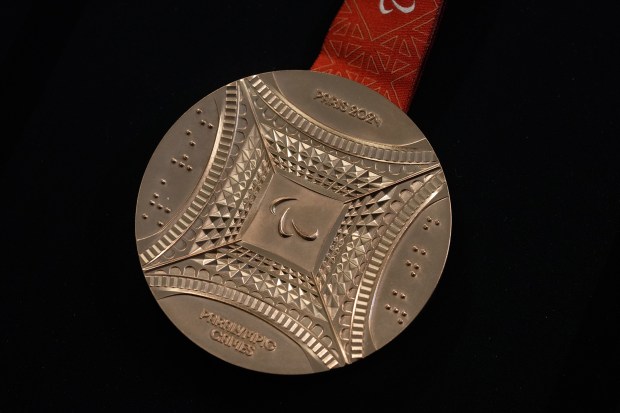 The Paris 2024 Paralympic bronze medal is presented to the press, in Paris, Thursday, Feb. 1, 2024. A hexagonal, polished piece of iron taken from the Eiffel Tower is being embedded in each gold, silver and bronze medal that will be hung around athletes' necks at the July 26-Aug. 11 Paris Games and Paralympics that follow. (AP Photo/Thibault Camus)