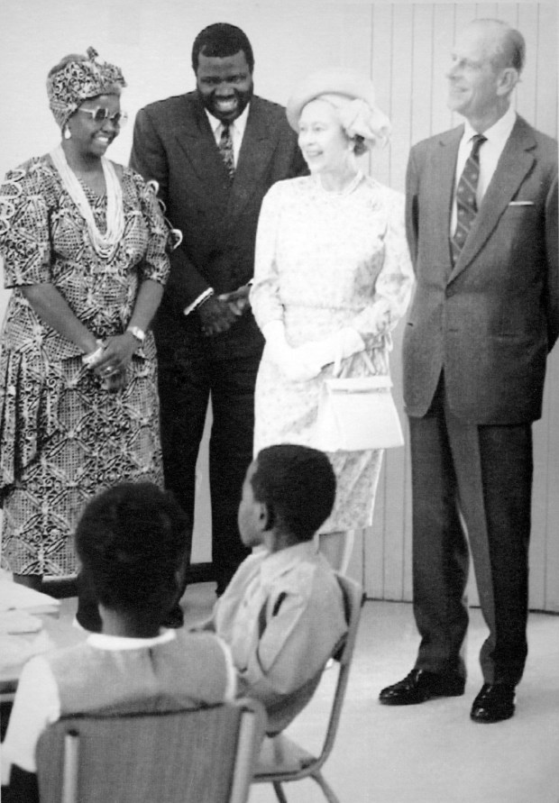 Britain's Queen Elizabeth II and her husband Prince Philip, Duke of Edinburgh,right, and Namibian Prime Minister Hage Geingob smile during her visit to the People's Primary School in Katutura, Namibia, on Oct. 10, 1991. (AP)