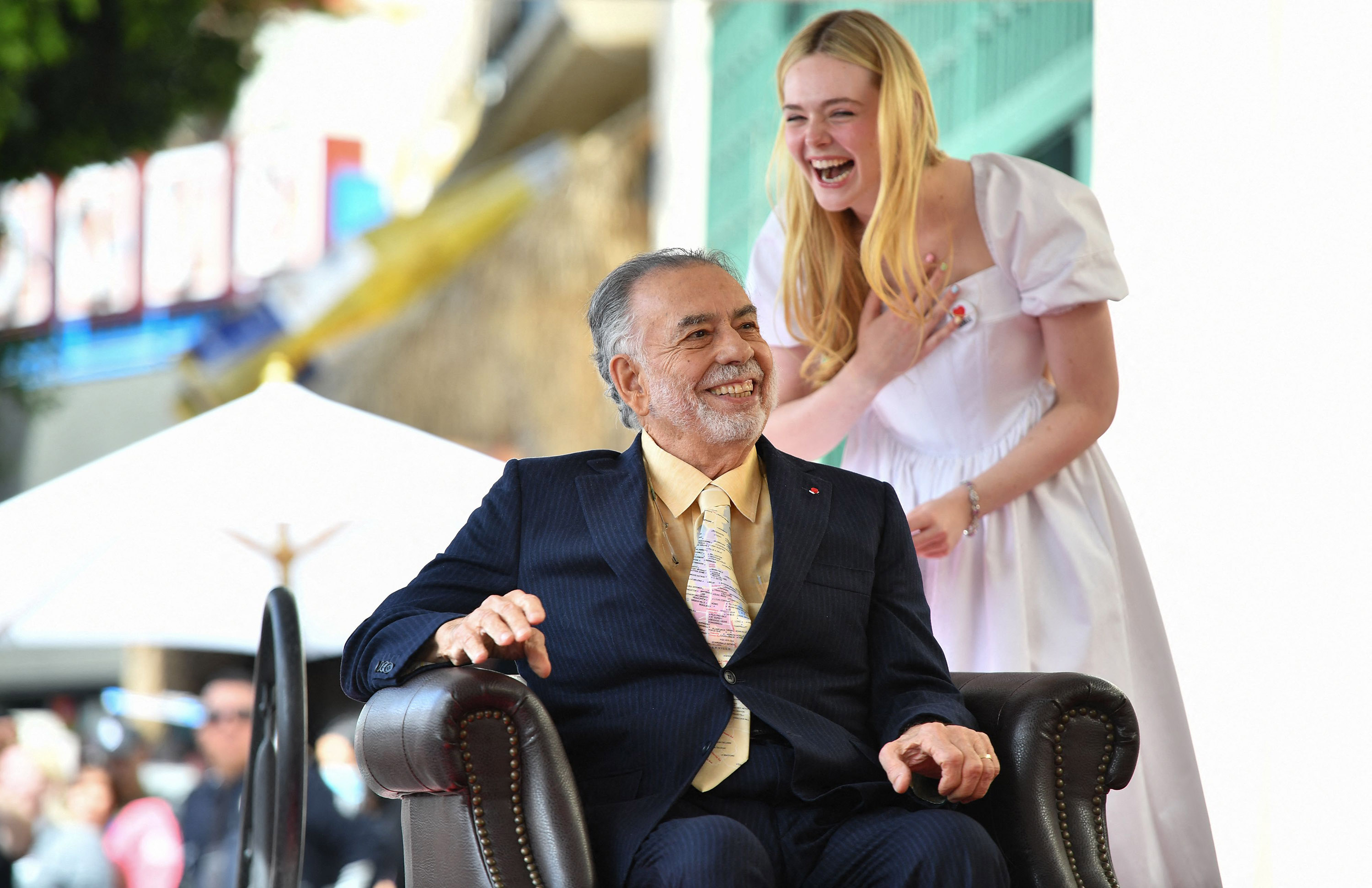 U.S. director Francis Ford Coppola and actress Elle Fanning laugh during Coppola's star ceremony on the Hollywood Walk of Fame on March 21, 2022, in Hollywood, Calif.