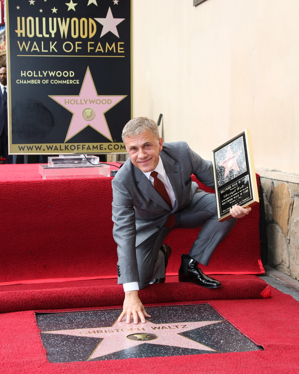 Actor Christoph Waltz smiles as he poses with his star and plaque on the Hollywood Walk of Fame. The German-Austrian actor, a favorite of director Quentin Tarantino, has appeared in films like 