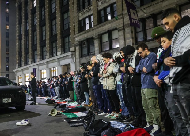 People perform congregational prayer on the street outside New York University building during a pro-Palestinian march demanding ceasefire in Gaza as they march from Brooklyn to Manhattan in New York City on Saturday, December 9, 2023. (Photo by Selcuk Acar/Anadolu via Getty Images)