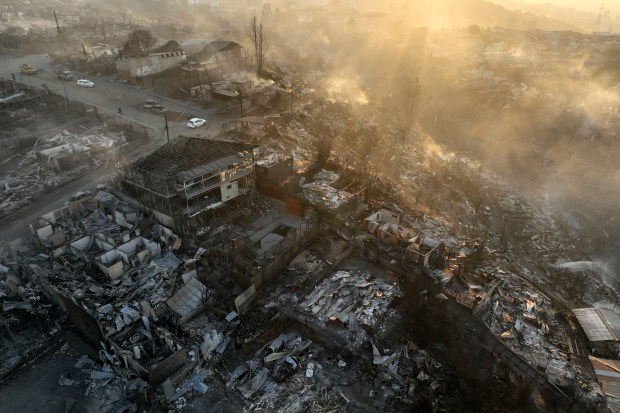 Aerial view of the aftermath of a fire at the hills in Viña del Mar, Chile on February 3, 2024. The region of Valparaoso and Viña del Mar, in central Chile, woke up on Saturday with a partial curfew to allow the movement of evacuees and the transfer of emergency equipment in the midst of a series of unprecedented fires, authorities reported. (Photo by Javier TORRES / AFP) (Photo by JAVIER TORRES/AFP via Getty Images)