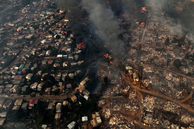 Aerial view of the forest fire that affects the hills of the city of Viña del Mar in the Las Pataguas sector, Chile, taken on February 3, 2024. The region of Valparaoso and Viña del Mar, in central Chile, woke up on Saturday with a partial curfew to allow the movement of evacuees and the transfer of emergency equipment in the midst of a series of unprecedented fires, authorities reported. (Photo by Javier TORRES / AFP) (Photo by JAVIER TORRES/AFP via Getty Images)