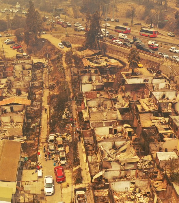 Aerial view of burned houses after a forest fire that affected the hills in Quilpe, Valparaiso region, Chile, taken on February 3, 2024. The region of Valparaoso and Viña del Mar, in central Chile, woke up on Saturday with a partial curfew to allow the movement of evacuees and the transfer of emergency equipment in the midst of a series of unprecedented fires, authorities reported. (Photo by RODRIGO ARANGUA / AFP) (Photo by RODRIGO ARANGUA/AFP via Getty Images)