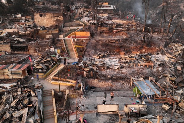 Aerial view of the aftermath of a wildfire in Villa Independencia, Valparaiso region, Chile on February 4, 2024. The death toll from the forest fires in Chile rose to 112 people this Sunday, while 40 active outbreaks are being fought, the Ministry of the Interior reported. (Photo by Javier TORRES / AFP) (Photo by JAVIER TORRES/AFP via Getty Images)