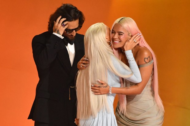 Colombian singer Karol G (R) accepts the Best Musica Urbana Album award for "Manana Sera Bonito" from Colombian singer Maluma (L) and US singer-songwriter Christina Aguilera (C) on stage during the 66th Annual Grammy Awards at the Crypto.com Arena in Los Angeles on February 4, 2024. (Photo by Valerie Macon / AFP) (Photo by VALERIE MACON/AFP via Getty Images)