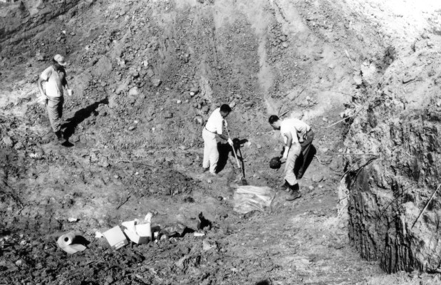 Investigators uncover the remains of civil rights volunteers Michael Schwerner, Andrew Goodman and James Chaney under thick red clay of an earthen dam near Philadelphia, Mississippi in July of 1964. The volunteers, all in their 20s, died at the hands of the Ku Klux Klan while working to register black voters during the Freedom Summer civil rights campaign in the segregated South. (National Archive/Newsmakers)