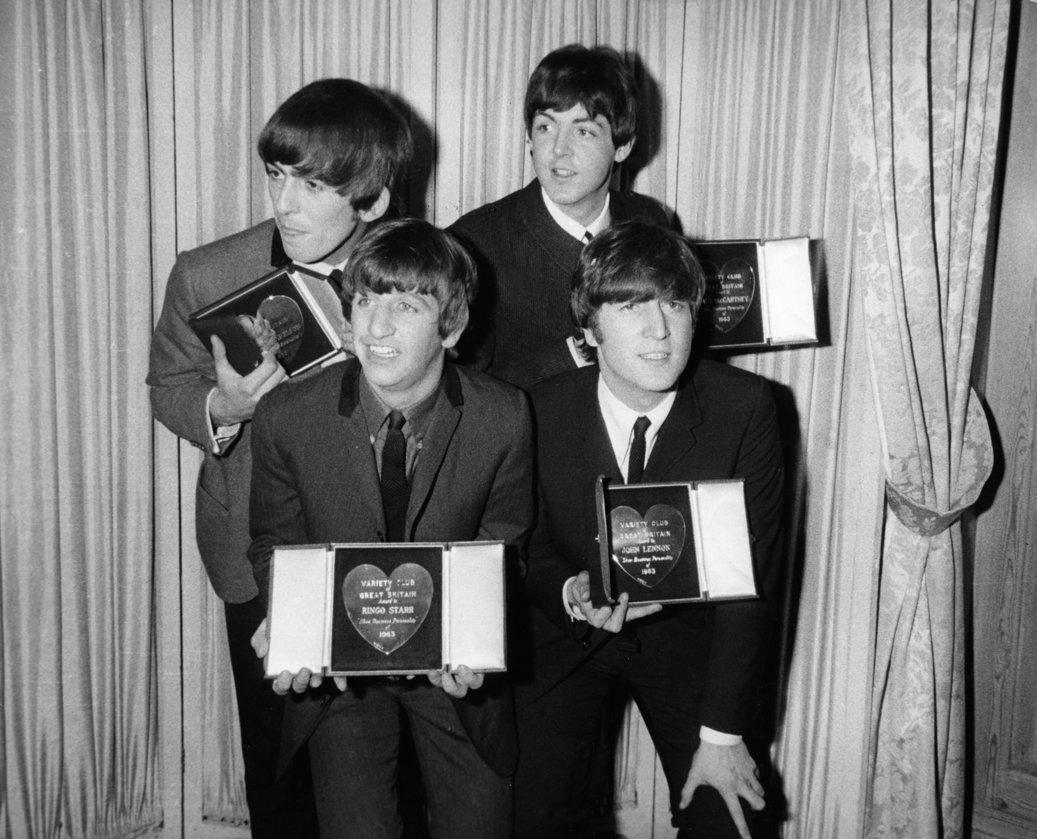 (l-r) George Harrison, Paul McCartney, front row, Ringo Starr and John Lennon of The Beatles receiving awards from the Variety Club of Great Britain in 1963.