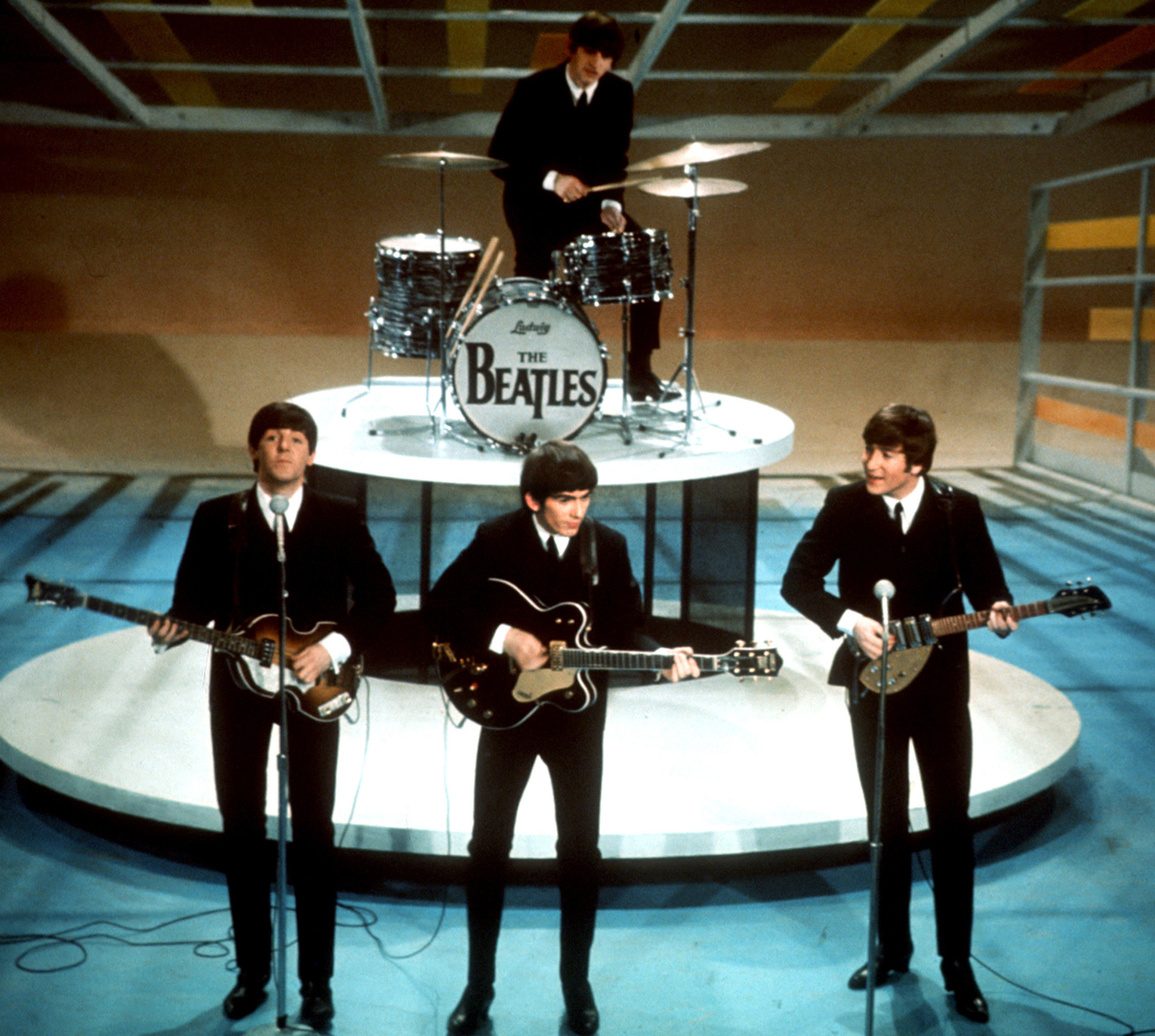 (l-r) Paul McCartney, George Harrison, John Lennon and Ringo Starr (on drums) of The Beatles perform on 