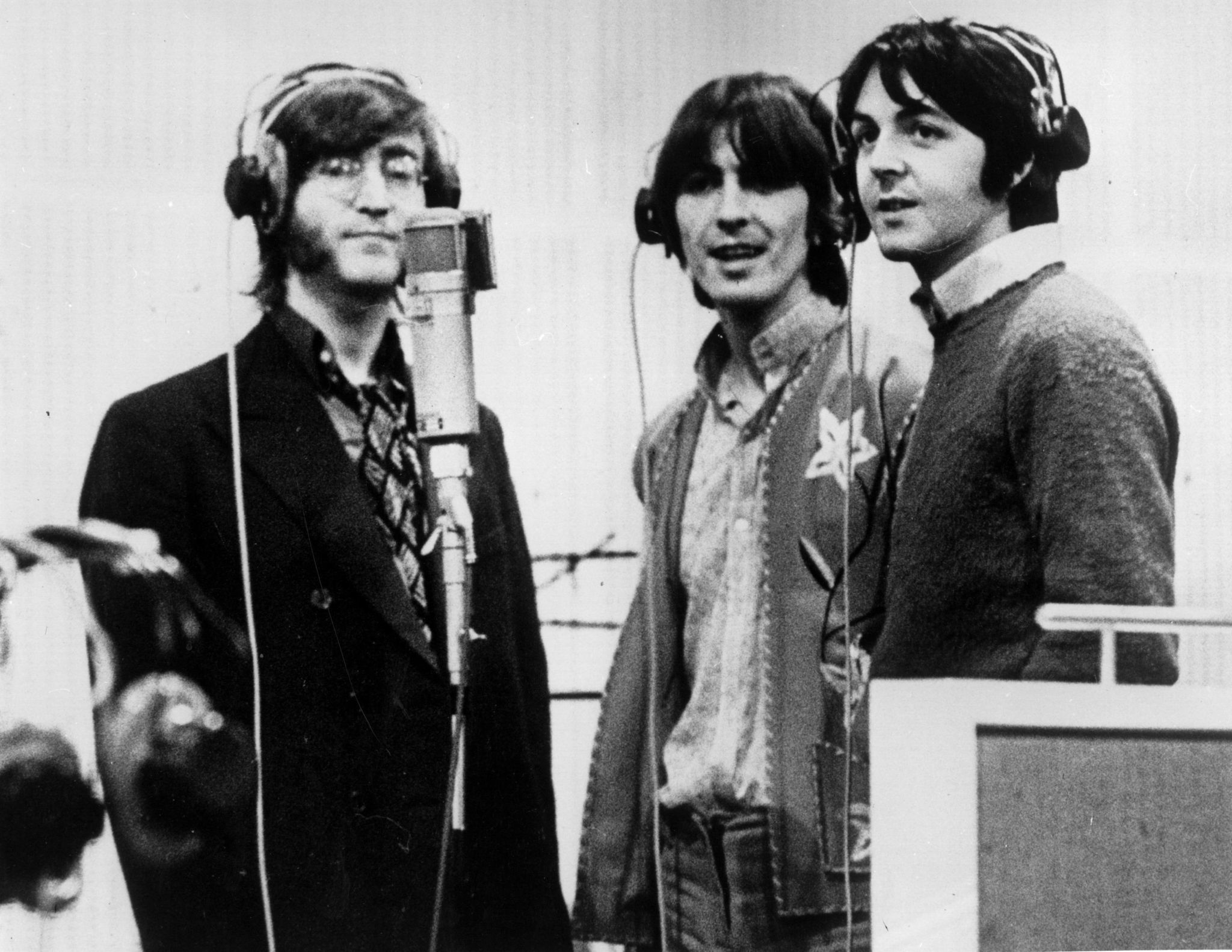 (l-r) John Lennon, George Harrison and Paul McCartney,record voices in a studio for their new cartoon film 