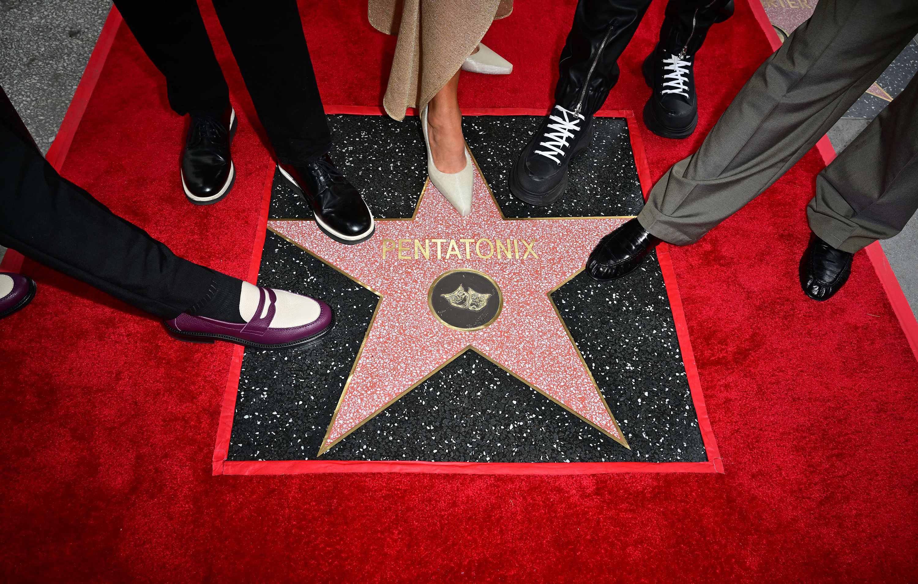 Members of the a cappella group Pentatonix pose for a photo with their newly unveiled Hollywood Walk of Fame star during a ceremony on Feb. 21, 2023, in Hollywood, Calif.