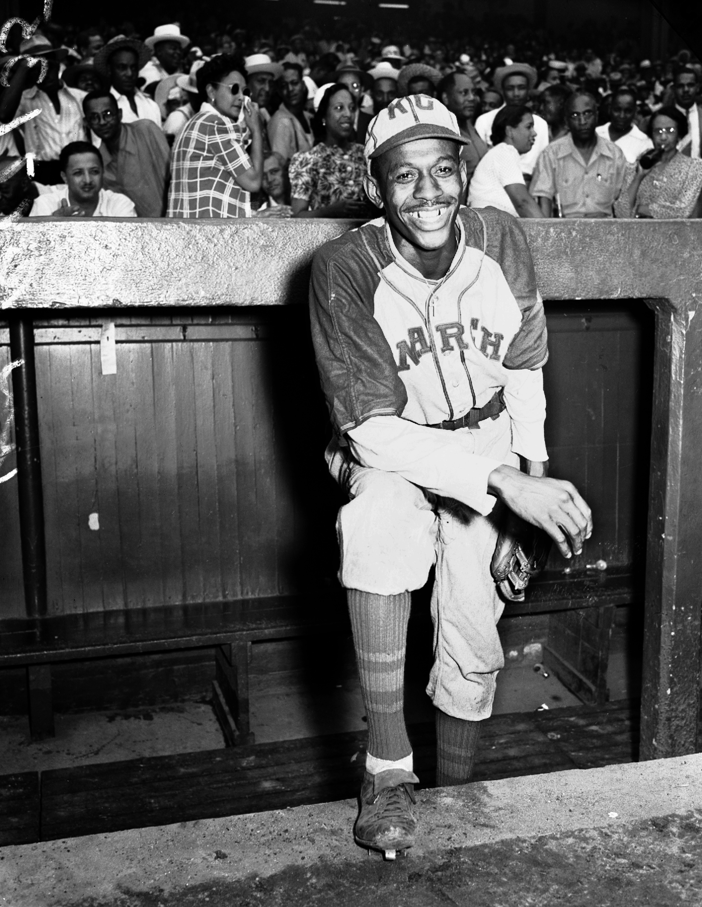 Kansas City Monarchs pitching great Satchel Paige is all smiles as he poses in the dugout at New York's Yankee Stadium on Aug. 2, 1942, for a Negro League game between the Monarchs and the New York Cuban Stars. Paige was considered a top prospect for the major leagues after baseball's commissioner ruled that there were no provisions barring players of color from the majors.