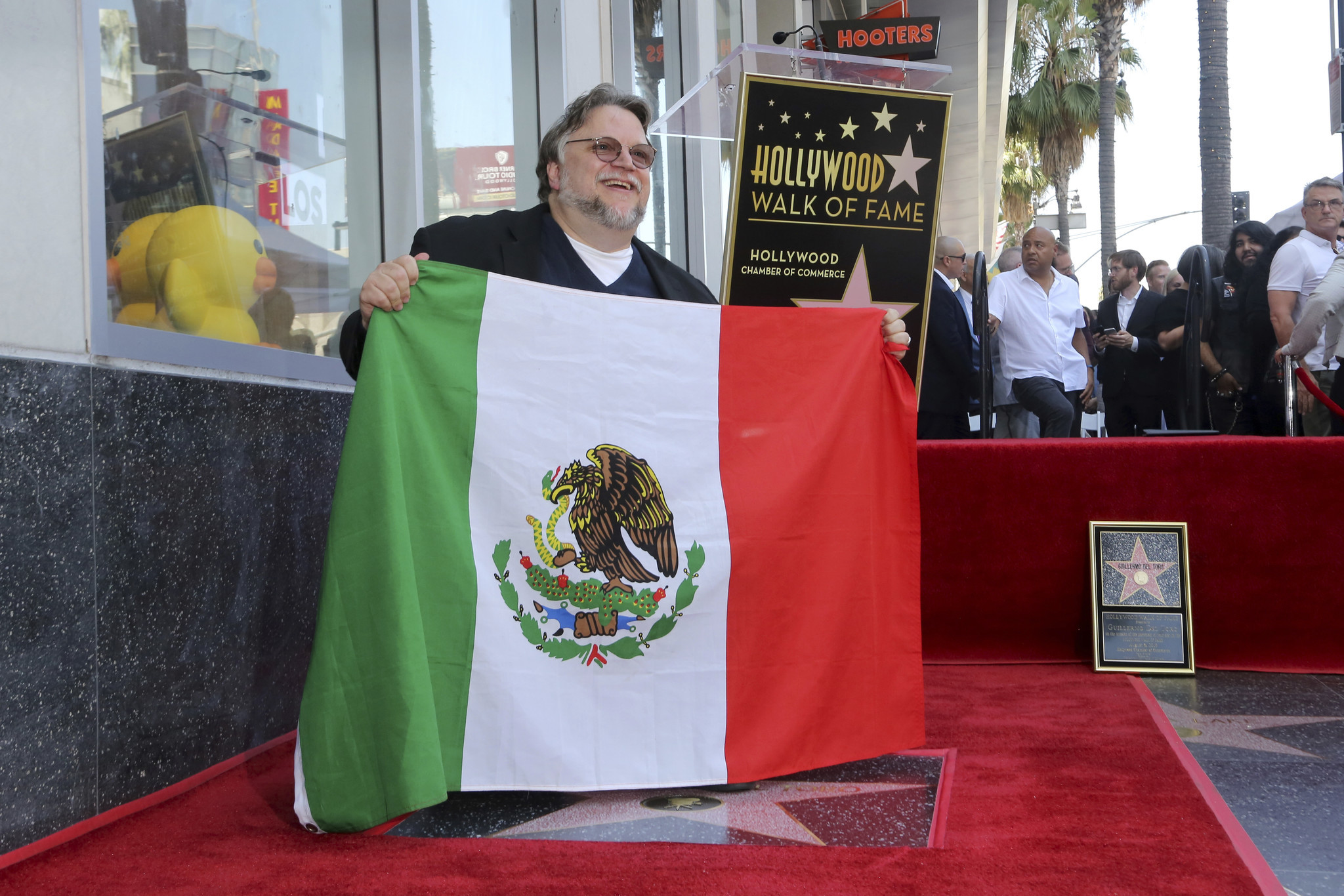 Filmmaker Guillermo del Toro proudly poses with the Mexican flag following his Hollywood Walk of Fame ceremony on August 6, 2019 in Los Angeles, Calif. The Mexican artist, who has brought modern classics including 