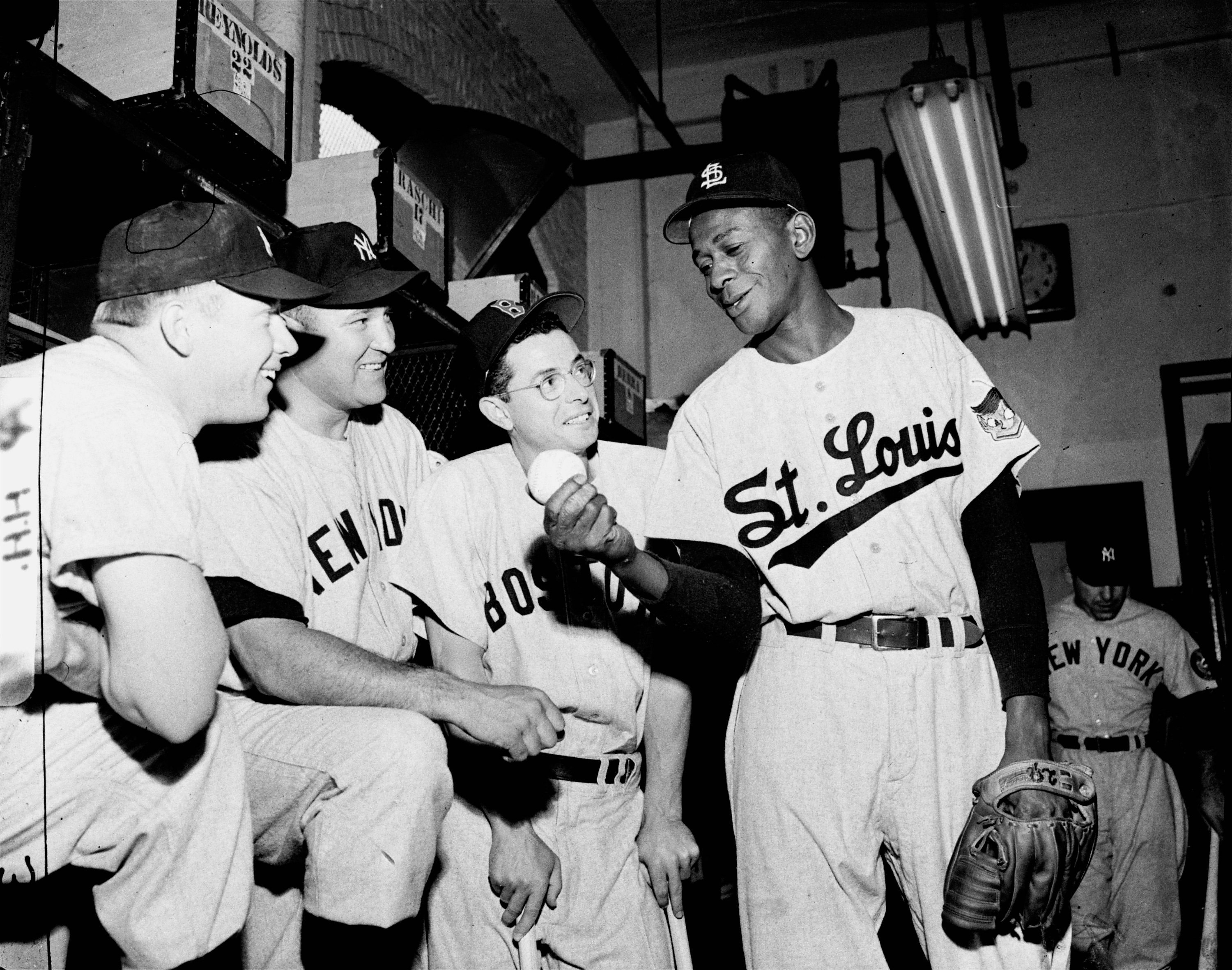 Satchel Paige of the St. Louis Browns (2R), a first time All-Star at 46, describes his pitch selection for some of his American League teammates, (l-r) Yankees outfielder Mickey Mantle, Yankees pitcher Allie Reynolds, Boston Red Sox outfielder Dom DiMaggio and Paige in the locker room at Philadelphia's Shibe Park on July 8, 1952.