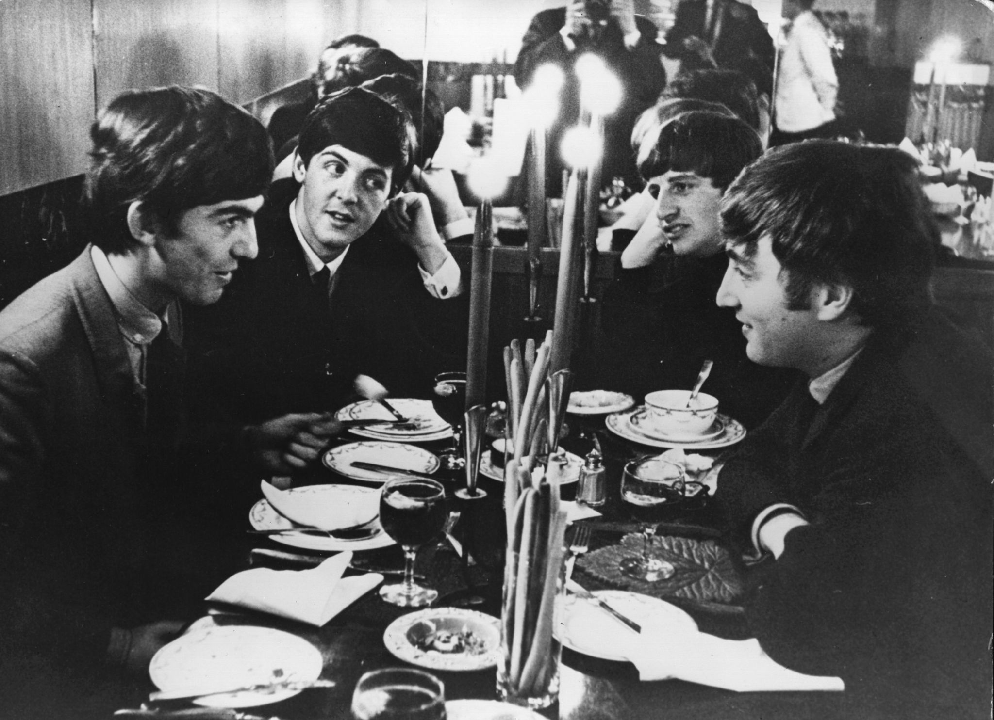 The Beatles meet for the first time after their holidays by candlelight at the Star Steak House in Shaftsbury Avenue, London on Oct. 5, 1963. That night, they appeared on the British music television program 