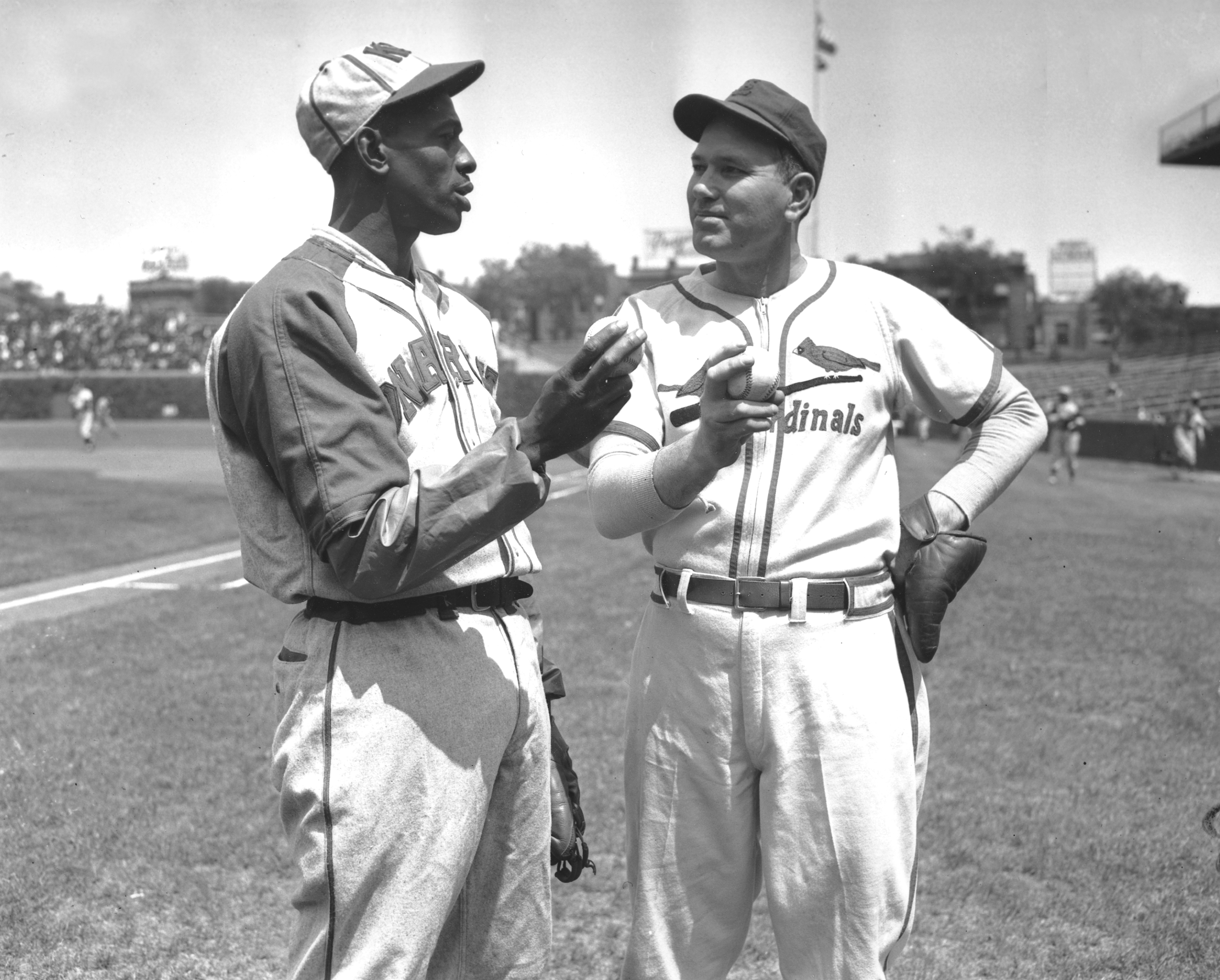 Satchel Paige of the Kansas City Monarchs (L) and former St. Louis Cardinal and Chicago Cubs hurler Dizzy Dean discuss pitching techniques before the start of a game at Wrigley Field in Chicago on May 24, 1942, between Dean's All-Stars and the Monarchs, an African-American team.