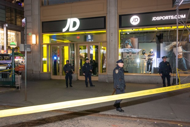 Police respond after a woman was shot inside the JD Sports store on Broadway and 41st Street in Times Square, Manhattan, New York City on Thursday, Feb. 8, 2024. (Gardiner Anderson for New York Daily News)