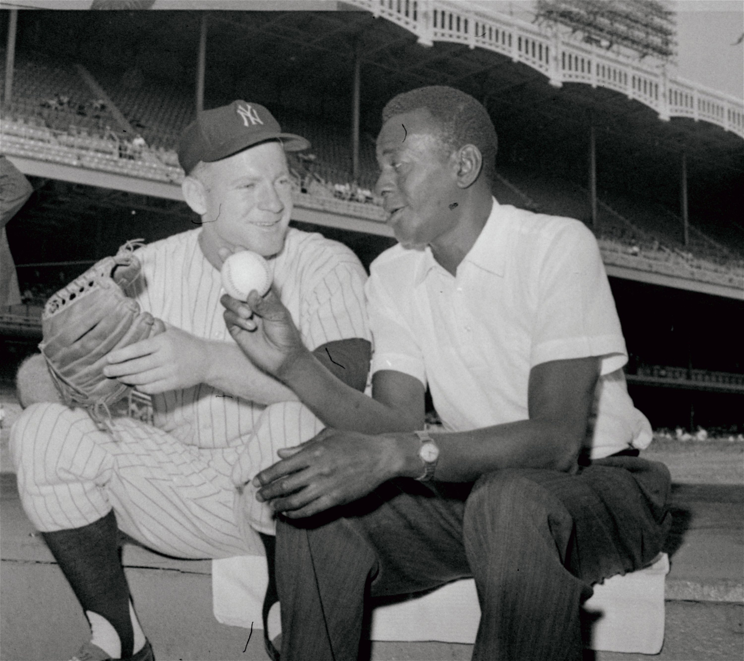 New York Yankee pitcher Whitey Ford, left, and Satchel Paige swap pitching talk on steps of the Yankee dugout in New York on Aug. 17, 1961. Paige and Ford talked before the Yankee game with Chicago White Sox, and the Yankees went on to win the game, 5-3.