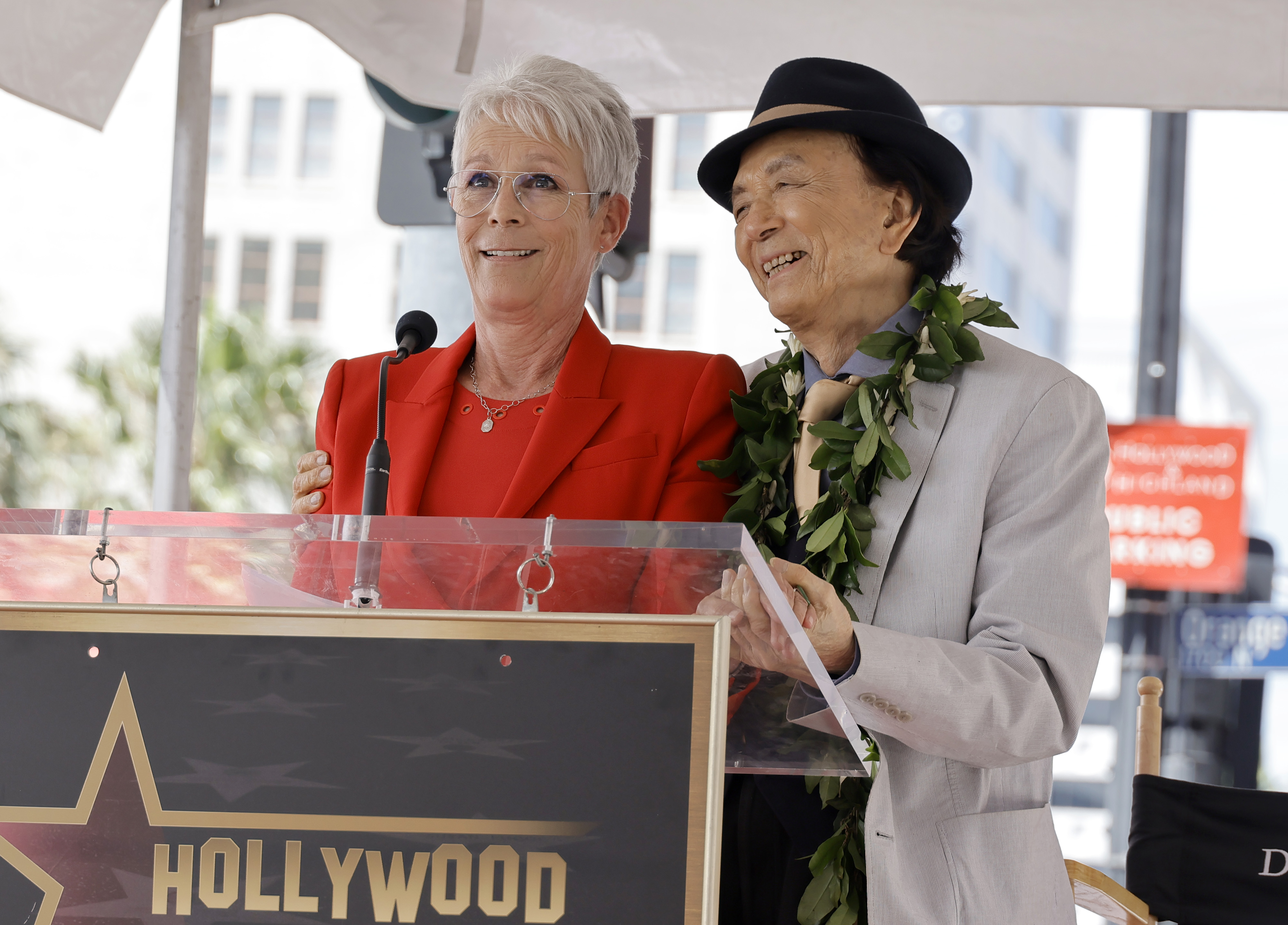 (L-R) Jamie Lee Curtis and James Hong speak onstage during the Hollywood Walk of Fame Star Ceremony for James Hong on May 10, 2022, in Hollywood, Calif.