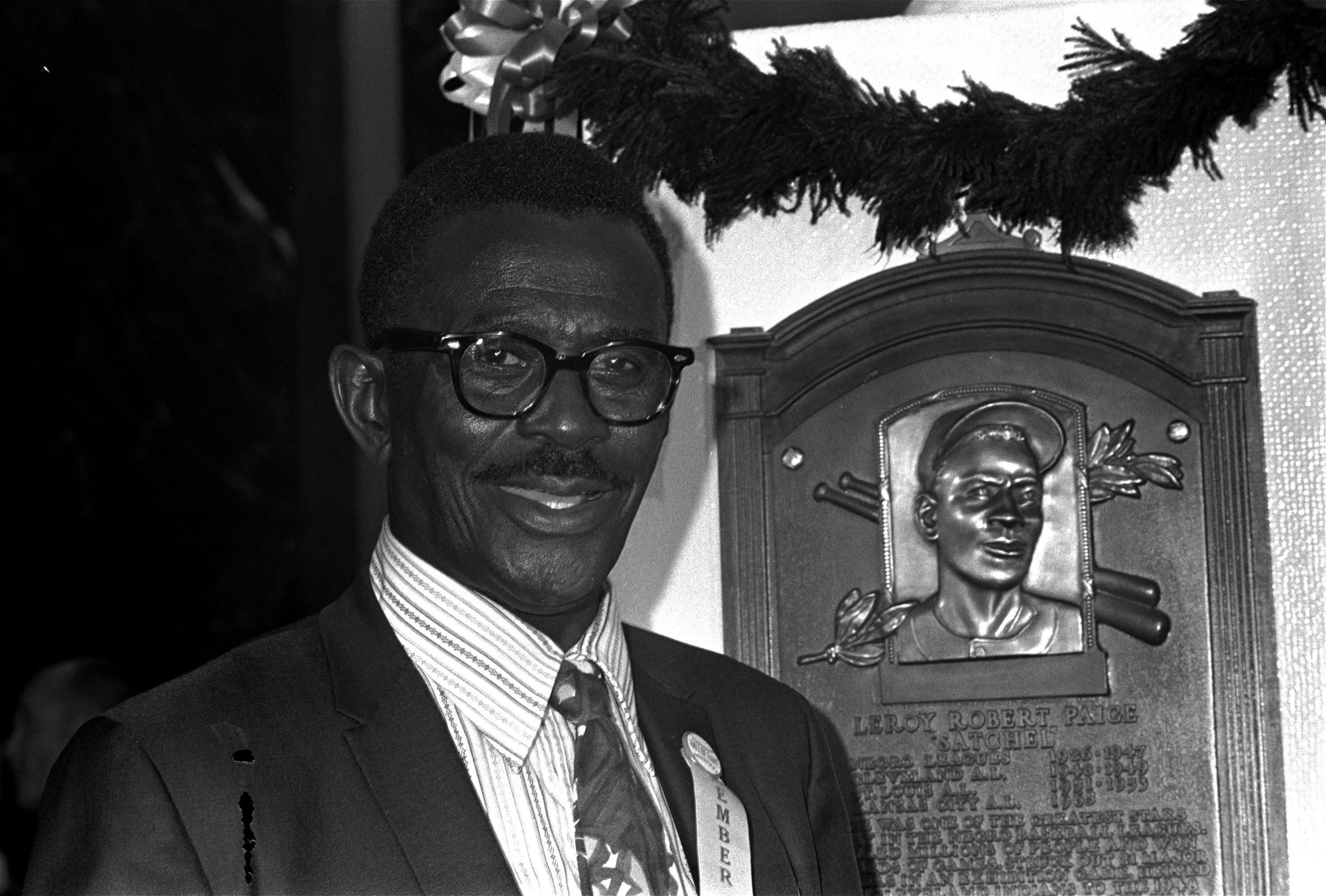 Satchel Paige poses in front of his plaque for the Baseball Hall Fame on Aug. 9, 1971.